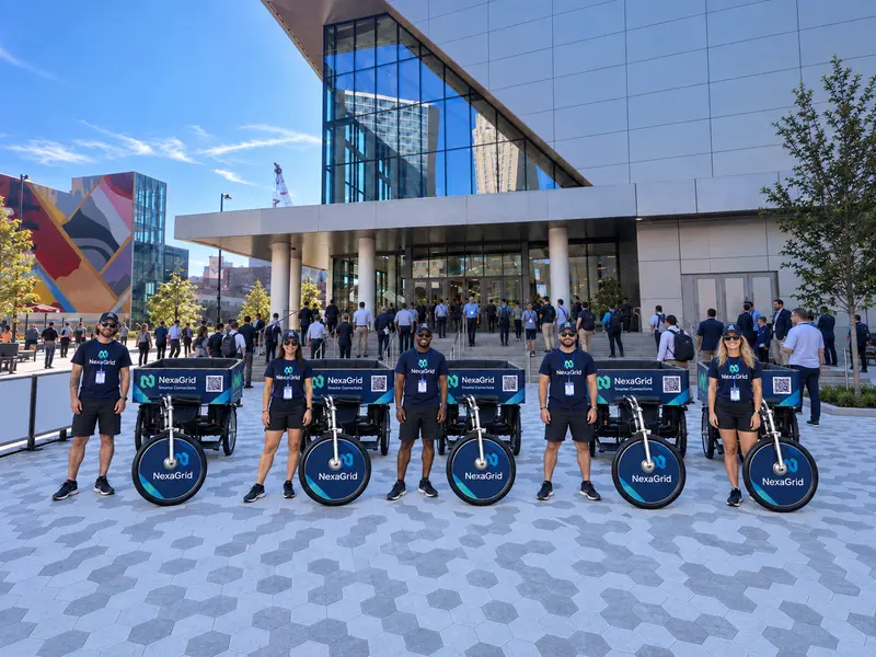 Fleet of sponsor-branded pedicabs and their drivers lined up outside the Cincinnati convention center